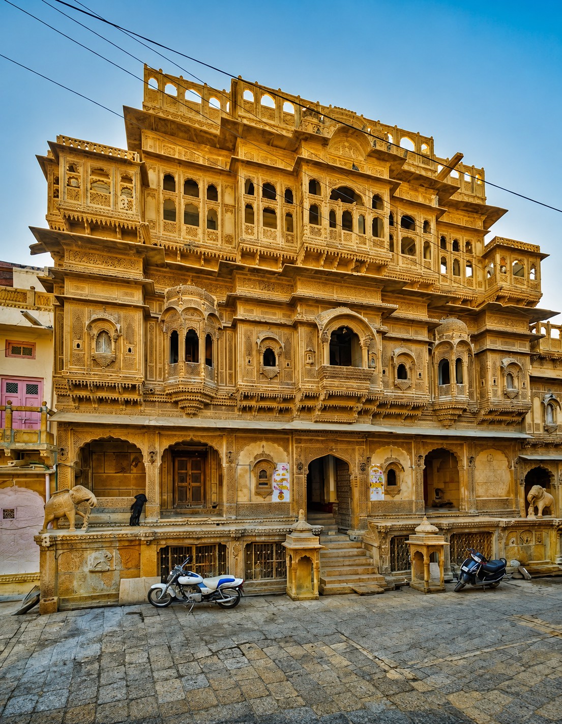 Intricately carved sandstone facade of Nathmal Ki Haveli with carved stone elephants